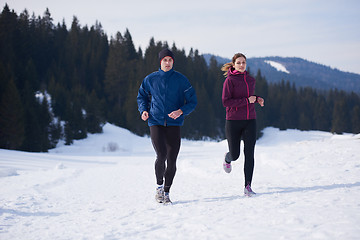 Image showing couple jogging outside on snow