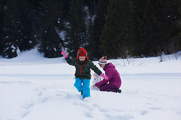 Image showing happy family building snowman