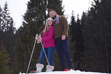 Image showing couple having fun and walking in snow shoes