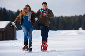 Image showing couple having fun and walking in snow shoes