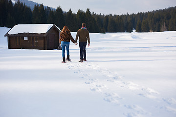 Image showing couple having fun and walking in snow shoes