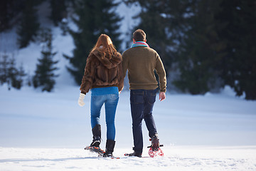 Image showing couple having fun and walking in snow shoes