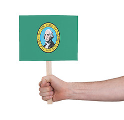 Image showing Hand holding small card - Flag of Washington