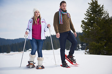 Image showing couple having fun and walking in snow shoes