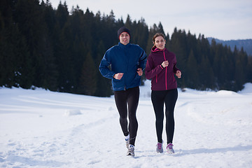 Image showing couple jogging outside on snow