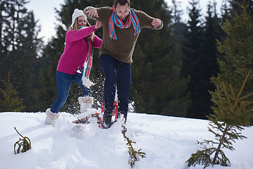 Image showing couple having fun and walking in snow shoes