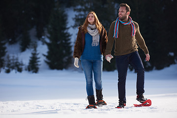 Image showing couple having fun and walking in snow shoes