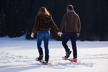 Image showing couple having fun and walking in snow shoes