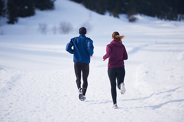 Image showing couple jogging outside on snow