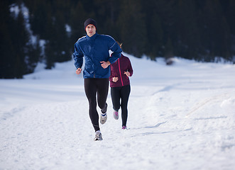 Image showing couple jogging outside on snow