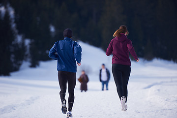 Image showing couple jogging outside on snow