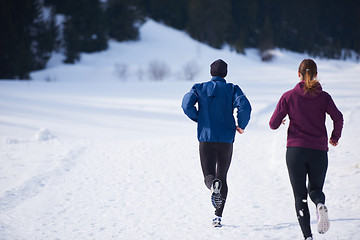 Image showing couple jogging outside on snow