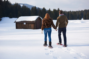 Image showing couple having fun and walking in snow shoes