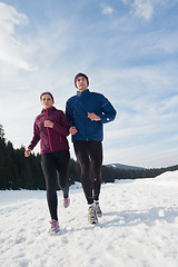 Image showing couple jogging outside on snow