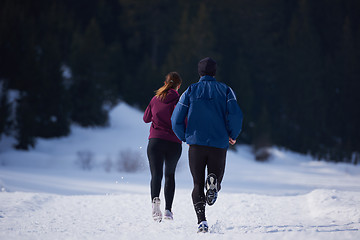 Image showing couple jogging outside on snow