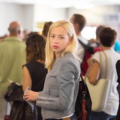 Image showing Young blond caucsian woman waiting in line.