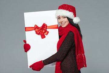 Image showing Woman in Santa hat holding white banner