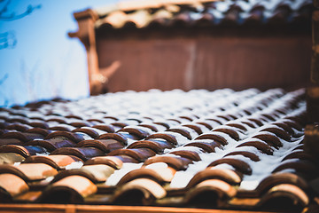 Image showing snow on red tiled roof