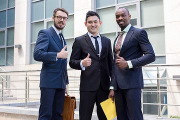 Image showing Portrait of business team holding their thumbs up