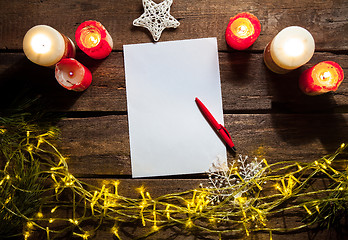 Image showing The blank sheet of paper on the wooden table with a pen 