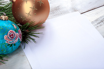 Image showing The sheet of paper on wooden table with Christmas decorations 