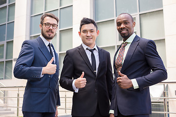 Image showing Portrait of business team holding their thumbs up