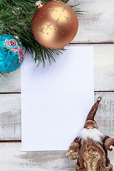 Image showing The sheet of paper on wooden table with Christmas decorations 