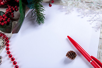 Image showing The blank sheet of paper on the wooden table with a pen 