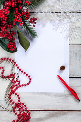 Image showing The blank sheet of paper on the wooden table with a pen 