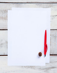 Image showing The blank sheet of paper on the wooden table with a pen 