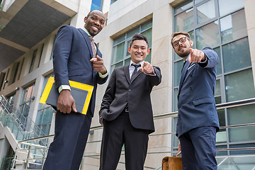 Image showing Close-up of business team holding their thumbs up