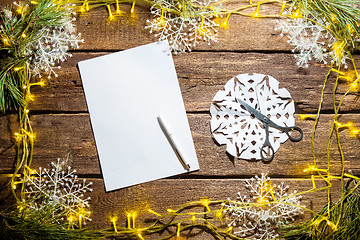 Image showing The blank sheet of paper on the wooden table with a pen 