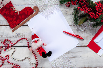 Image showing The blank sheet of paper on the wooden table with a pen 