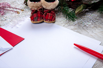 Image showing The blank sheet of paper on the wooden table with a pen 