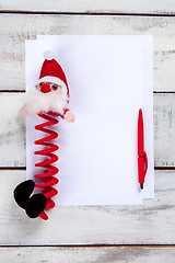 Image showing The blank sheet of paper on the wooden table with a pen 