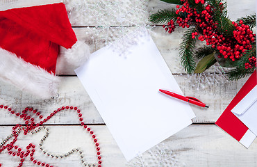 Image showing The blank sheet of paper on the wooden table with a pen 