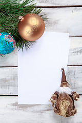 Image showing The sheet of paper on wooden table with Christmas decorations 