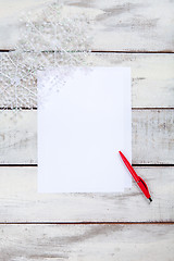 Image showing The blank sheet of paper on the wooden table with a pen 