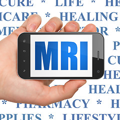 Image showing Healthcare concept: Hand Holding Smartphone with MRI on display