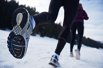 Image showing couple jogging outside on snow