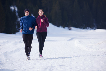 Image showing couple jogging outside on snow