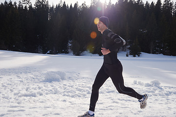 Image showing jogging on snow in forest