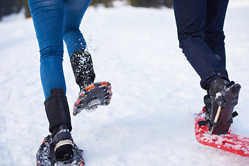 Image showing couple having fun and walking in snow shoes