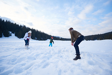 Image showing happy family playing together in snow at winter