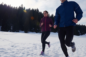 Image showing couple jogging outside on snow