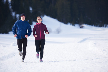 Image showing couple jogging outside on snow