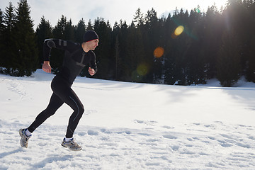 Image showing jogging on snow in forest