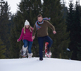 Image showing couple having fun and walking in snow shoes