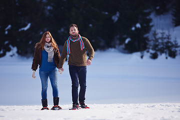 Image showing couple having fun and walking in snow shoes