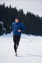 Image showing jogging on snow in forest